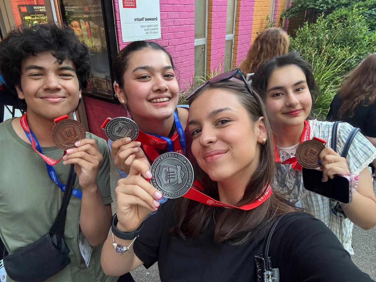 Four CST students smiling with their IGO medals