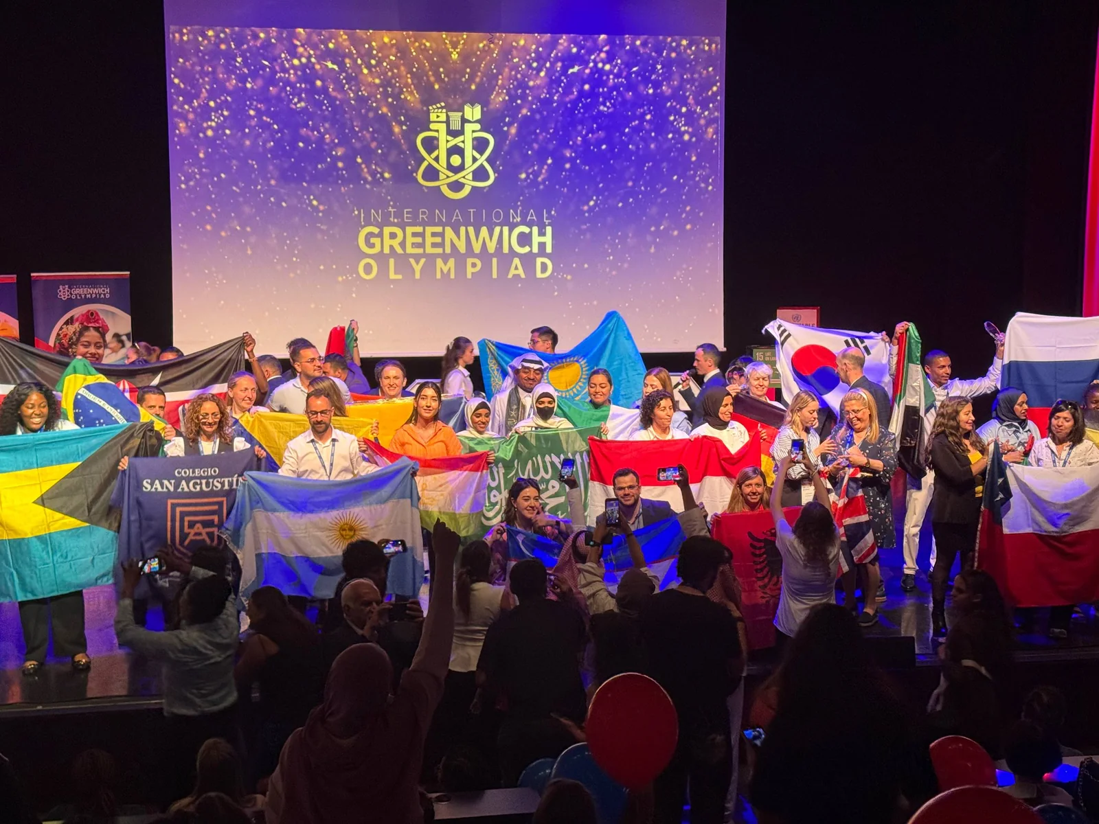 A wide view of the IGO finals stage filled with flags