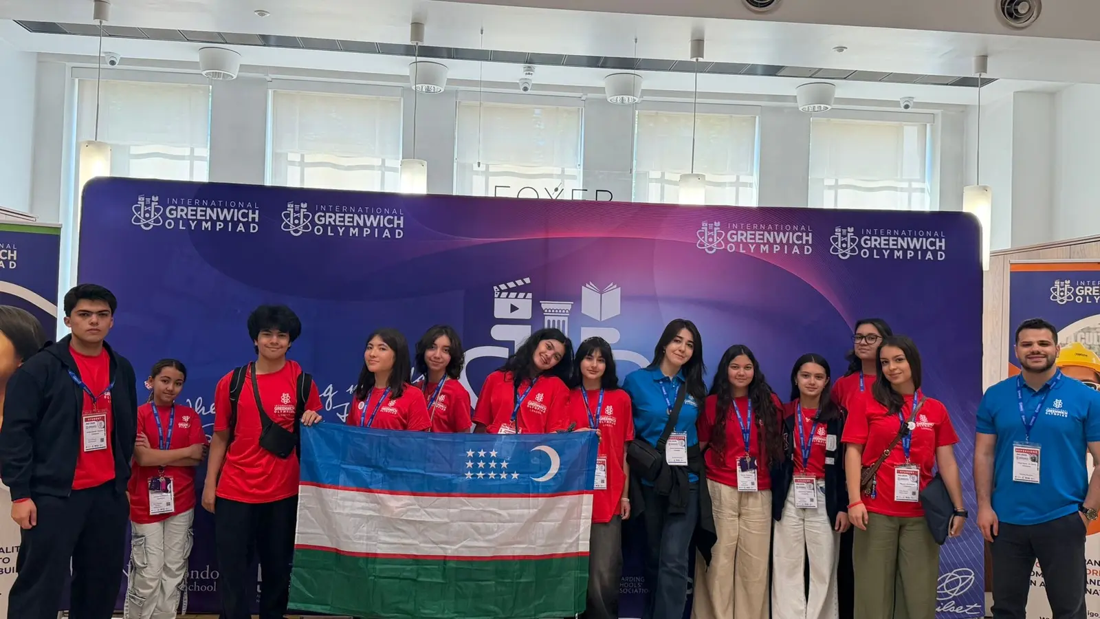 CST students holding the flag of Uzbekistan