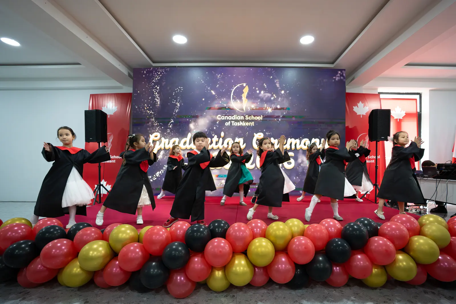 Kindergarten students performing on stage at their graduation ceremony