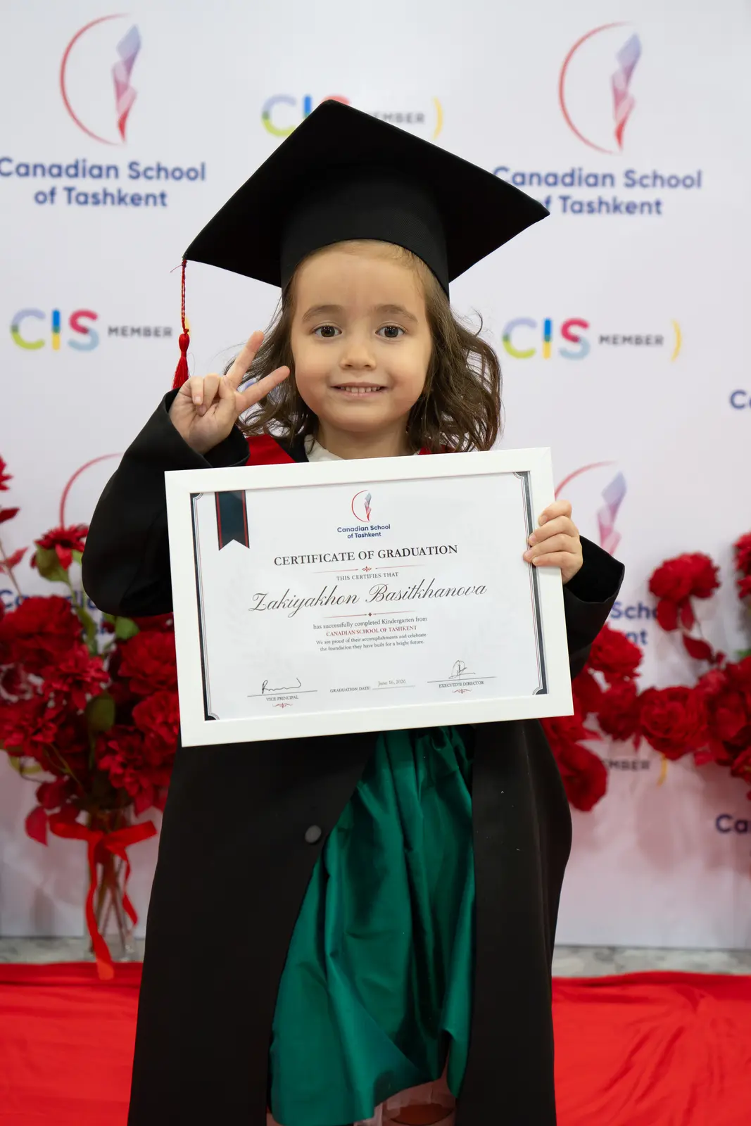 A kindergarten graduate holding her certificate