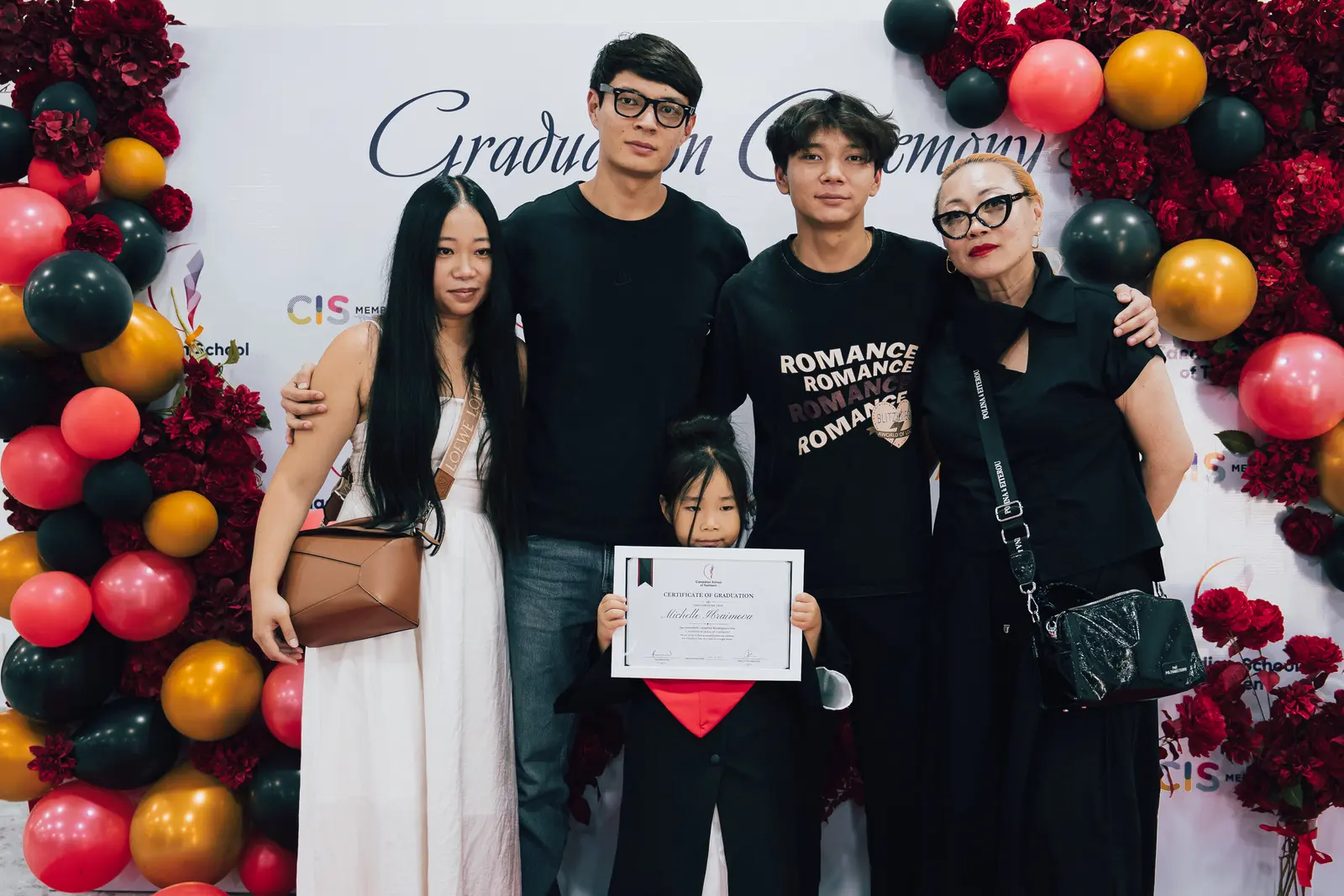 A family celebrating their kindergarten graduate